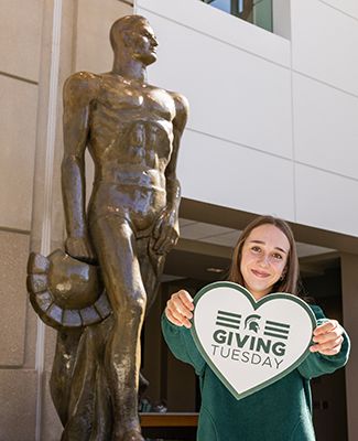 MSU students with a Giving Tuesday sign