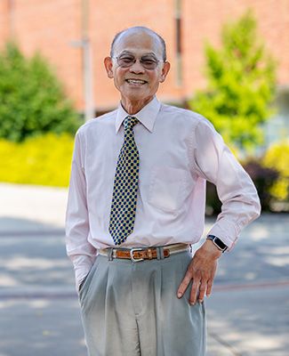 Portrait of Keelung Hong standing outside the MSU Main Library.