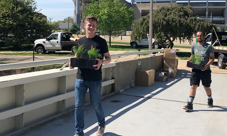 Spartan student carrying a planter