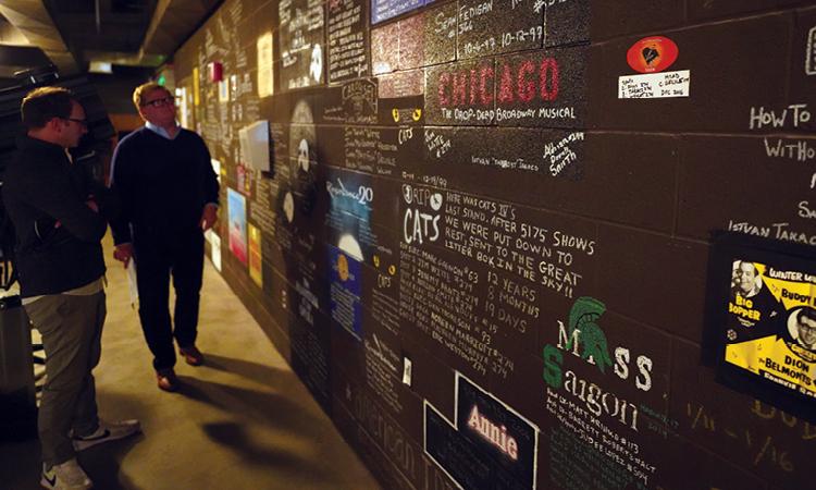 Behind the scenes, walls are adorned with art and signatures created by past touring companies.