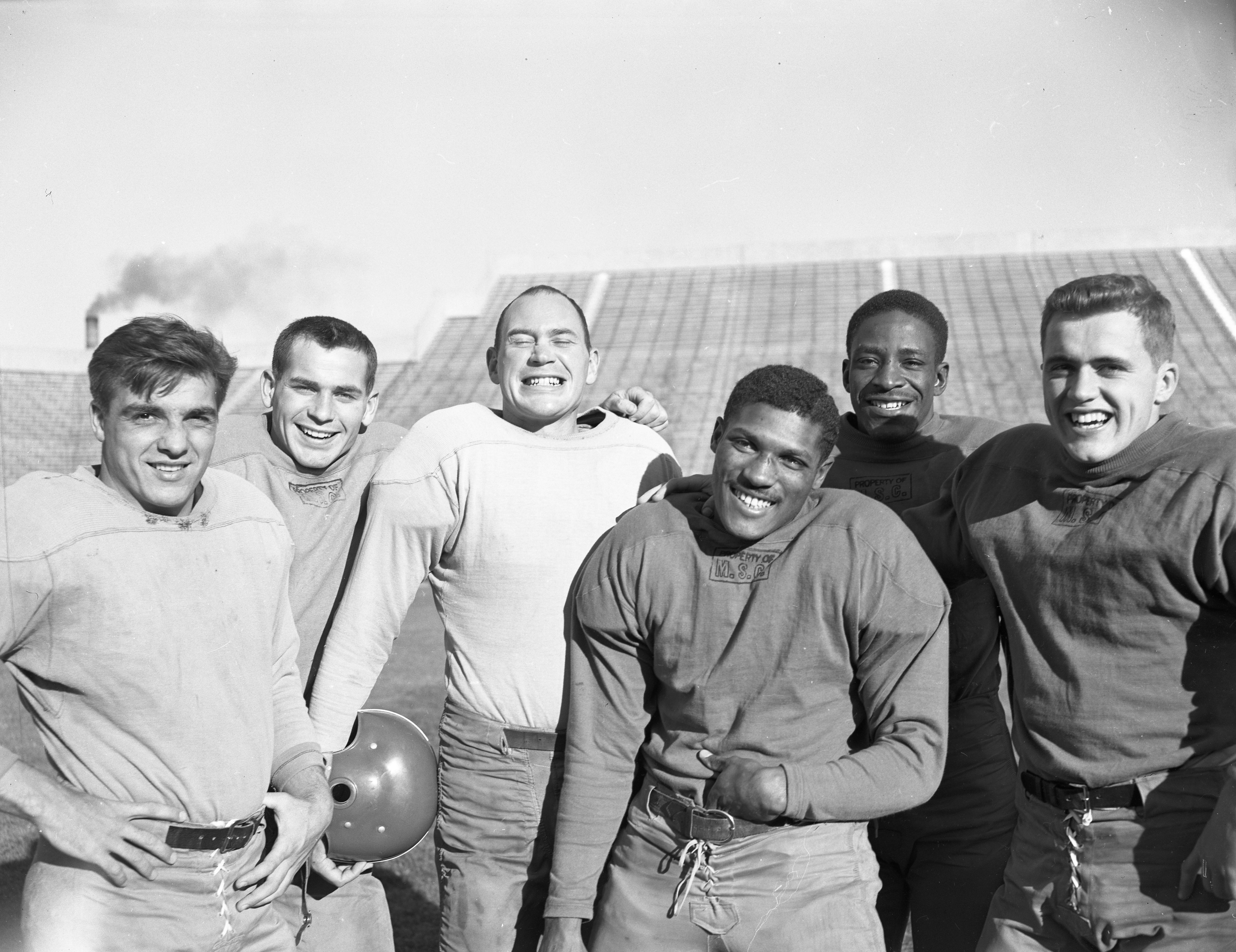 A group photograph of six football players. Second from the right is Willie Thrower. Others not identified.