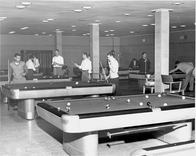 Playing pool in the billiard room, 1949.