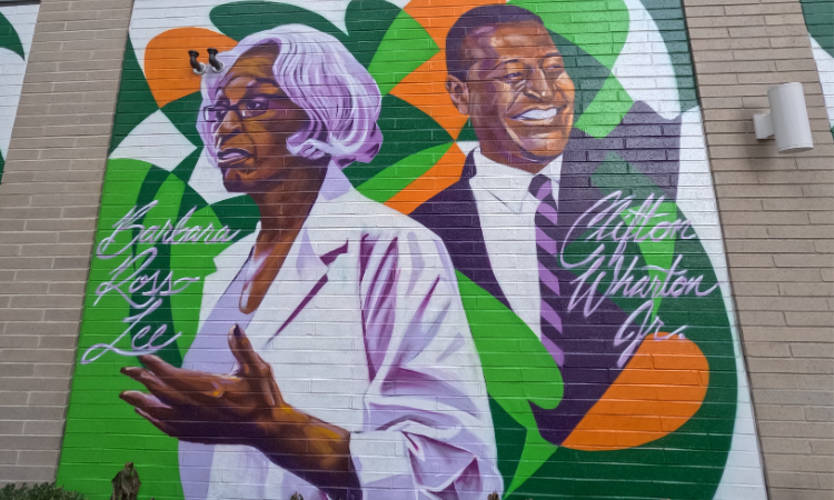 A mural of Dr. Barbara Ross-Lee and Clifton Wharton on the Graduate Hotel by Jacob Dwyer, 2021.