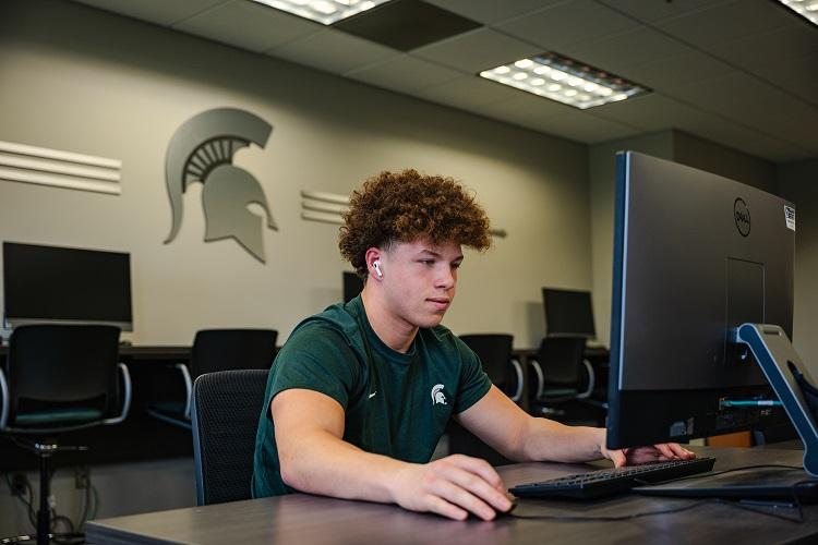 Football defensive back Caleb Gash works out of the computer lab.