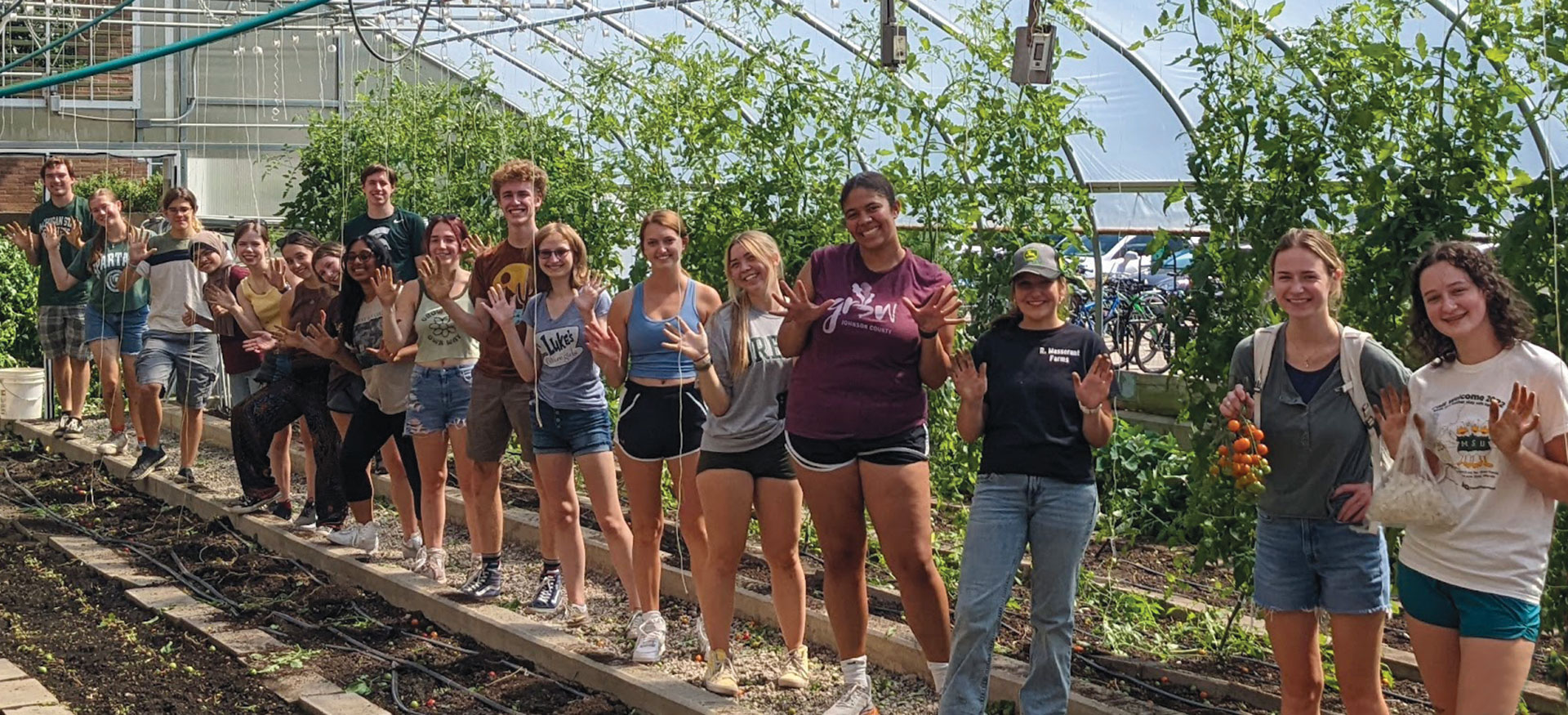 A group of RISE students standing in a line in the Bailey GREENhouse. 