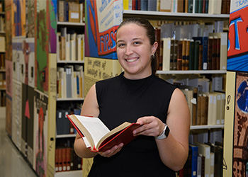 Morgan Schwarz holds a book in the newly renovated Special Collections space.