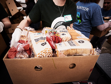 Volunteers packing food at the MSU Food Bank.