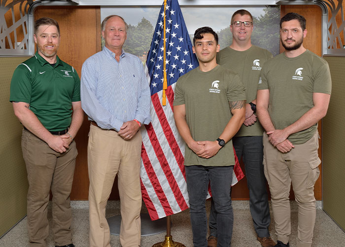 Photo MSU student veterans posing for a photo with a donor at the SVRC. 