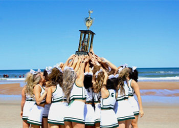 MSU cheerleaders with trophy